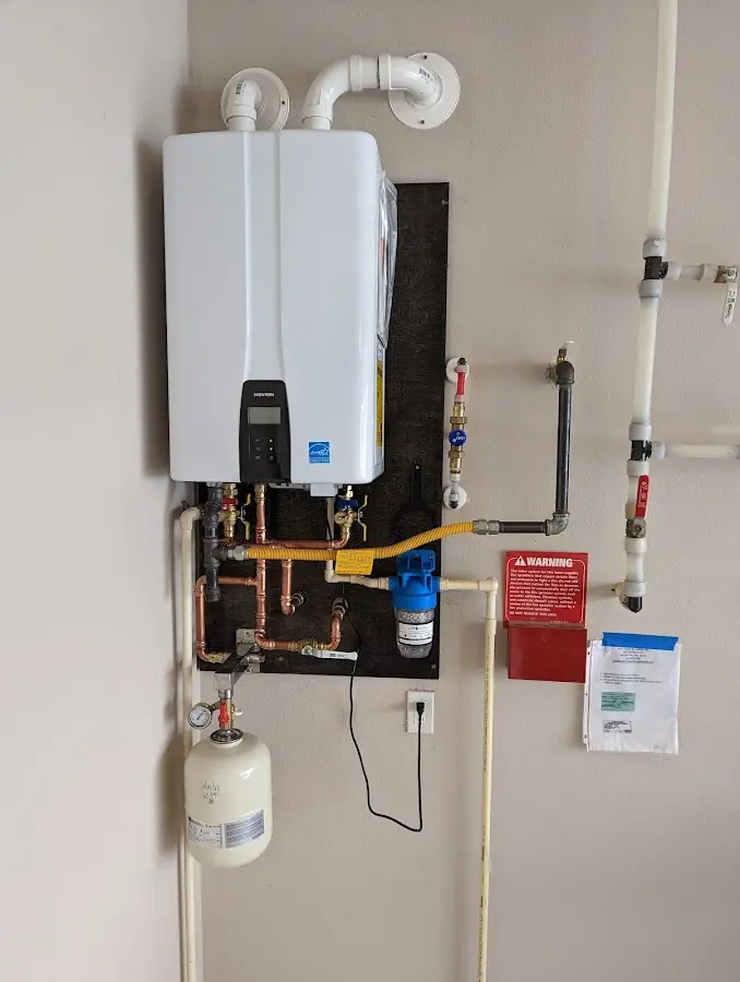 Professional plumber installing copper piping in a Camanche home